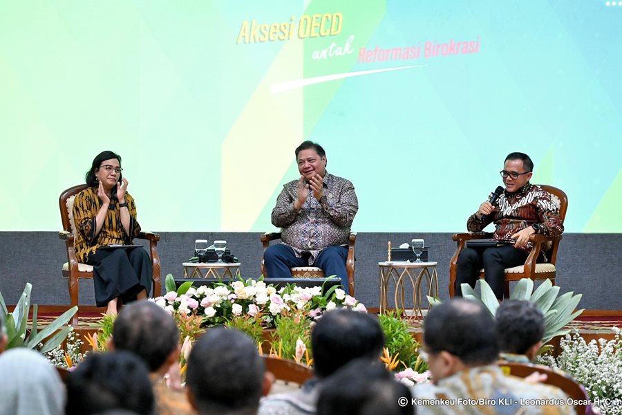 A group of people sitting and discussing in a formal setting